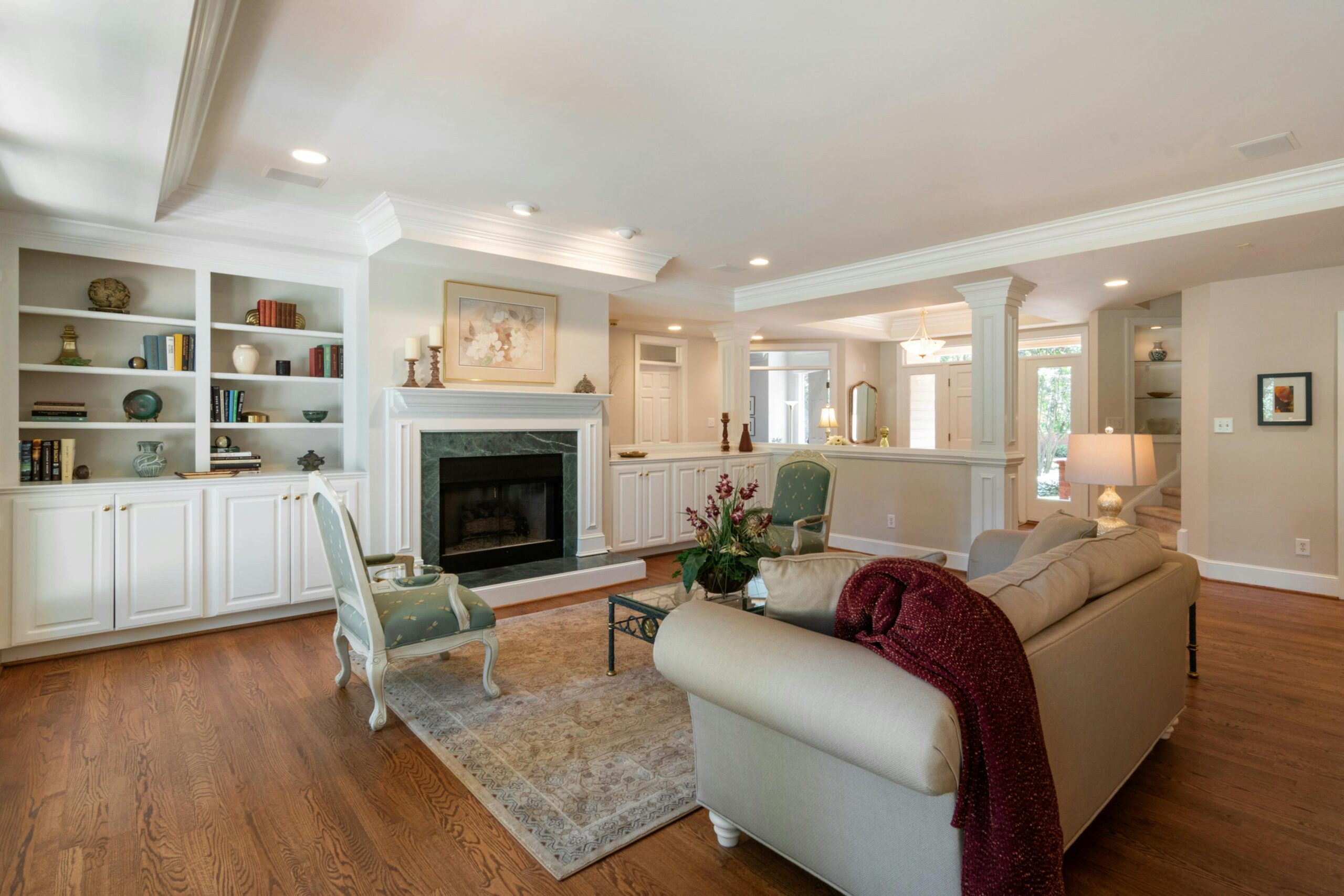 Spacious living room featuring elegant decor, a classic fireplace, and comfortable seating.